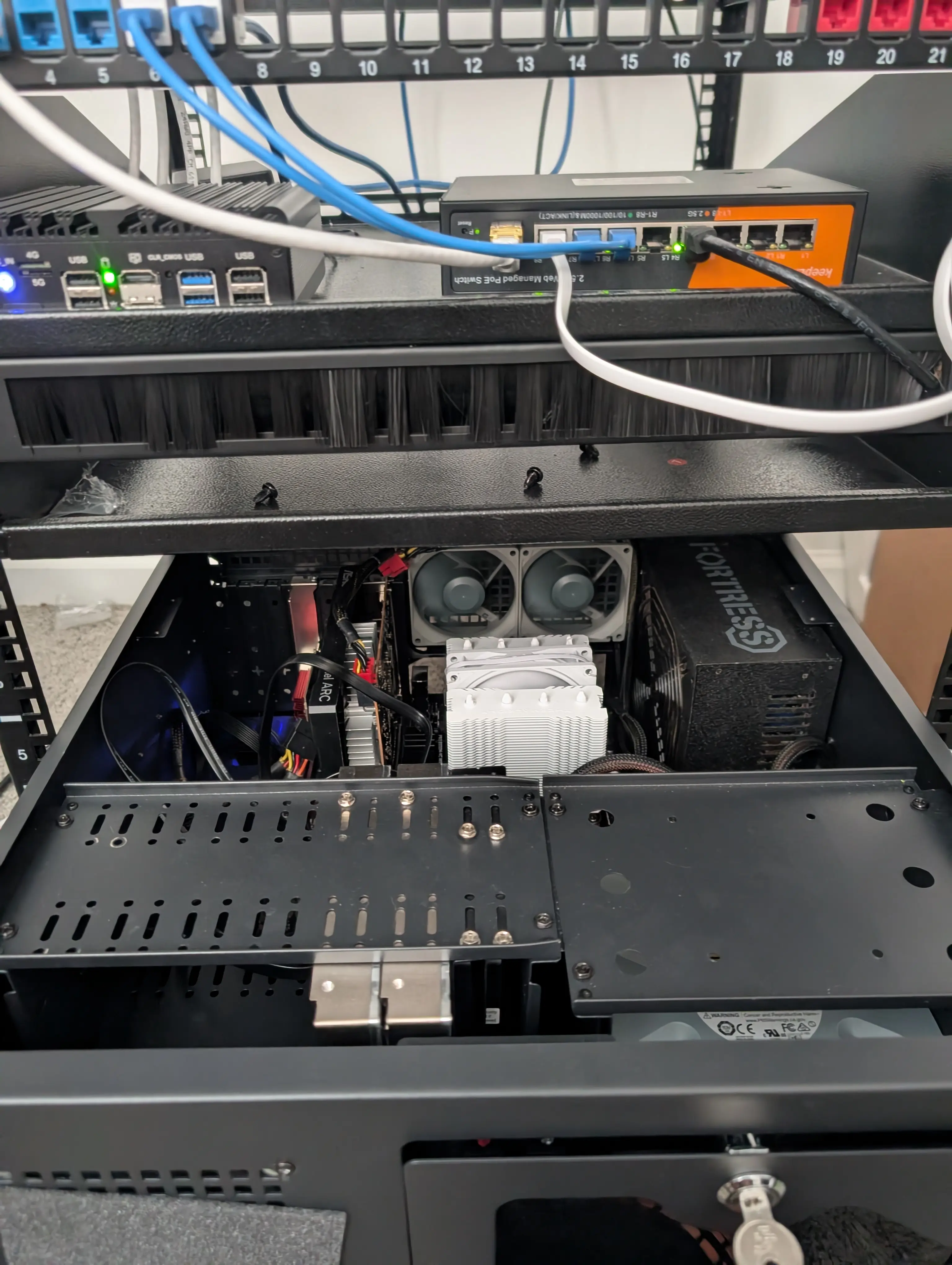 A well-organized home server setup with network equipment and cables